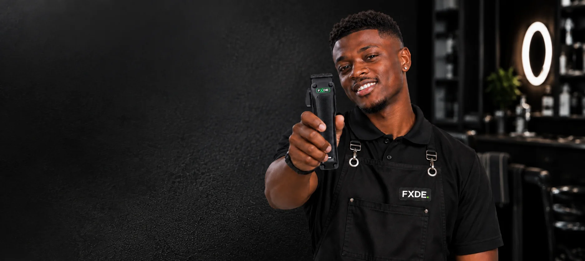 FXDE barber holding a cordless clipper